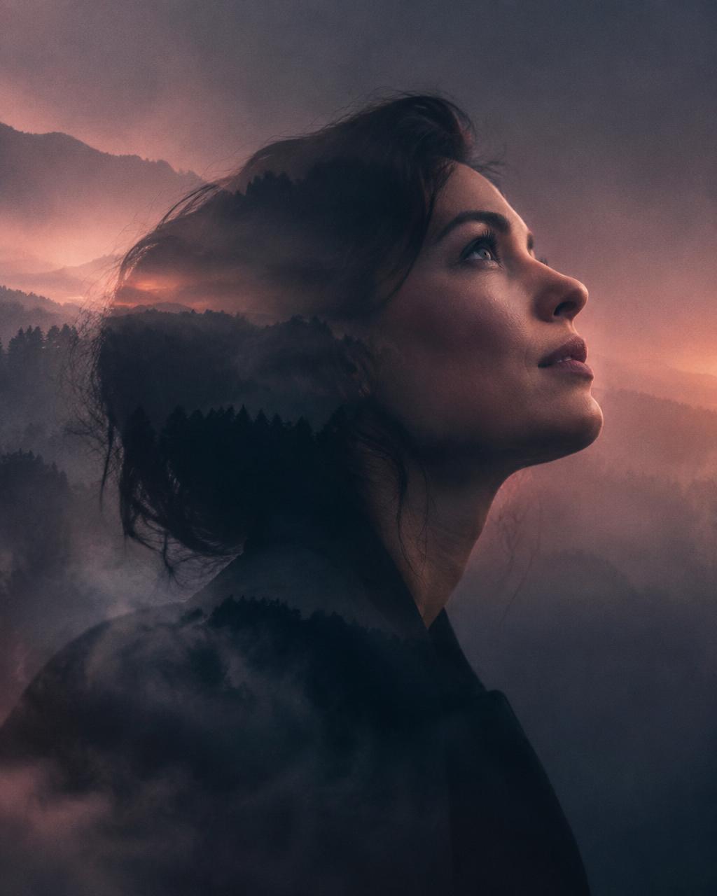 A woman looking upward in soft evening light